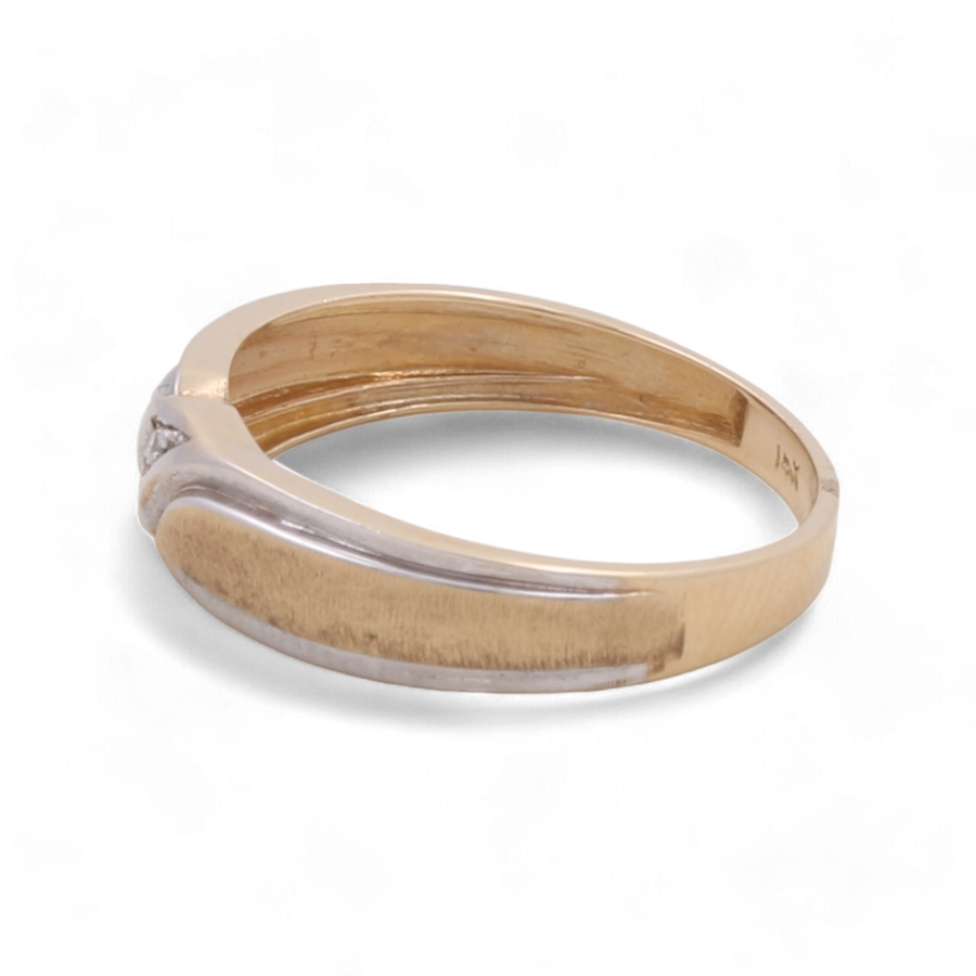 The 14K Yellow Gold Wedding Men Ring by Miral Jewelry features a curved band and a small diamond accent on one side, making it a timeless piece perfect for any occasion.