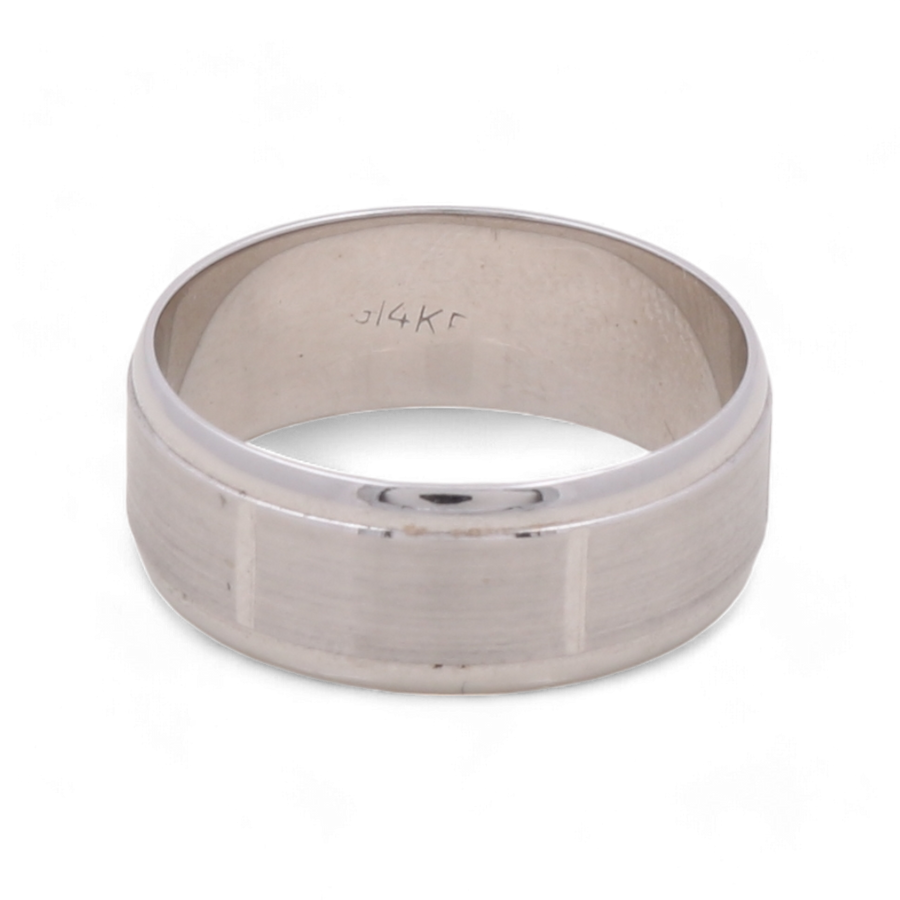 A 14K White Gold Wedding Ring by Miral Jewelry, featuring a smooth finish and inscribed with "314K" on the inner surface, offering a timeless design.