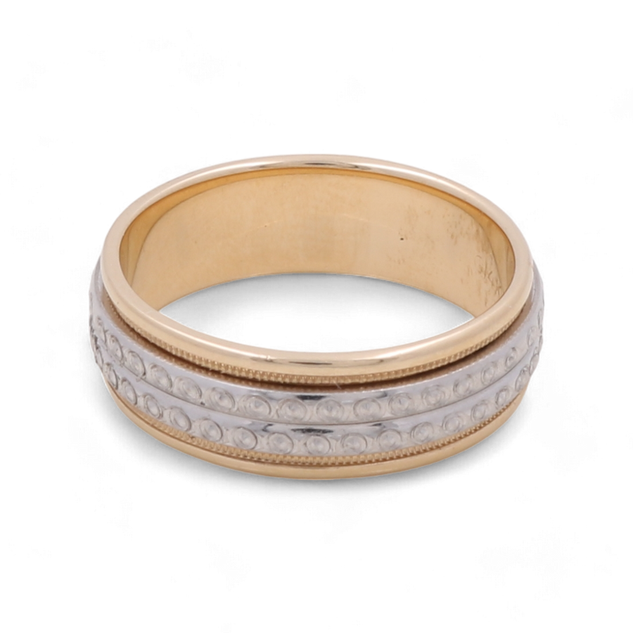 A luxurious 14K yellow and white gold wedding ring by Miral Jewelry, featuring a central white band with intricate small circular designs.