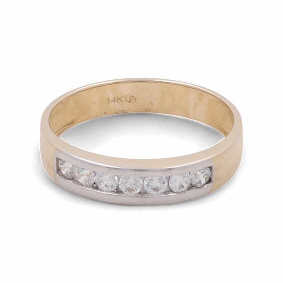 Experience the elegance of Miral Jewelry's 14K Yellow and White Gold Wedding Men Ring, featuring a row of seven sparkling zirconia stones set in a sophisticated channel setting. The interior of this stunning two-tone gold ring is gracefully engraved with "14K," highlighting its premium quality.