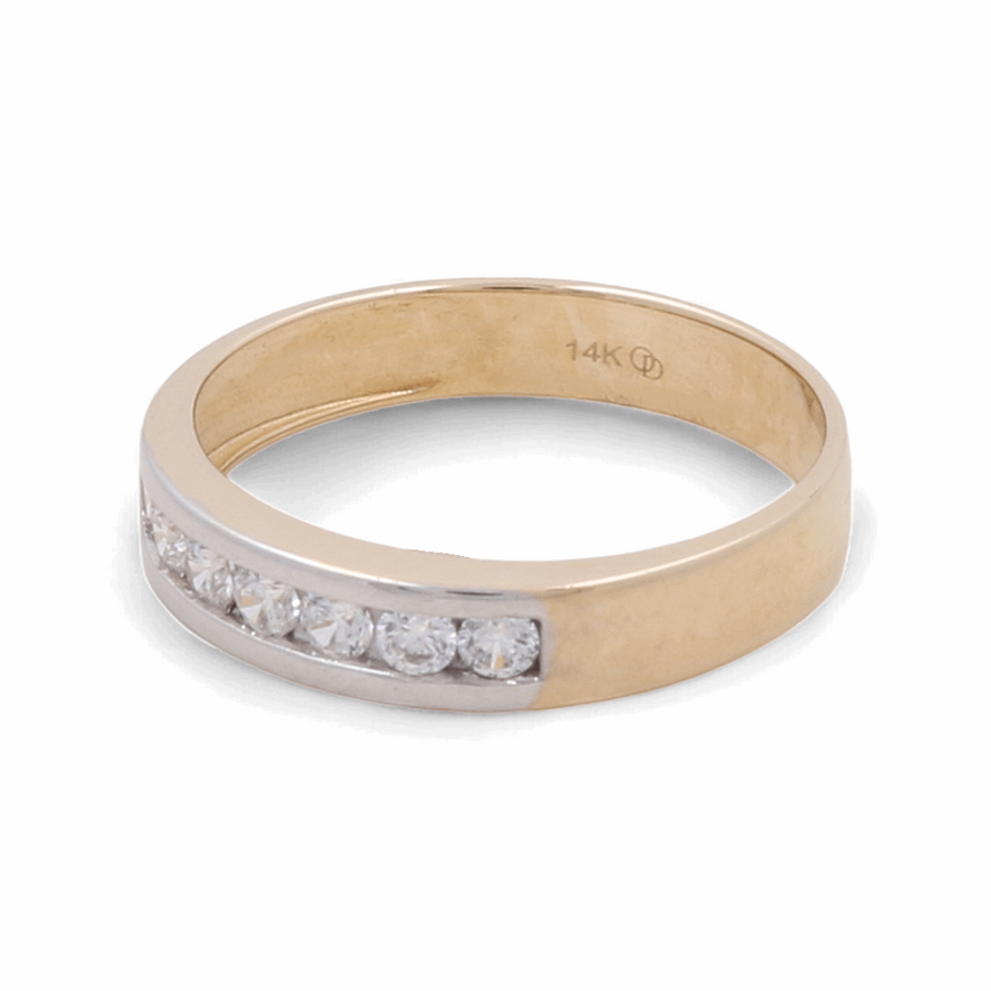 The 14K Yellow and White Gold Wedding Men Ring, crafted by Miral Jewelry, showcases a striking row of small zirconia stones set along the top half, ensuring a timeless and elegant design.