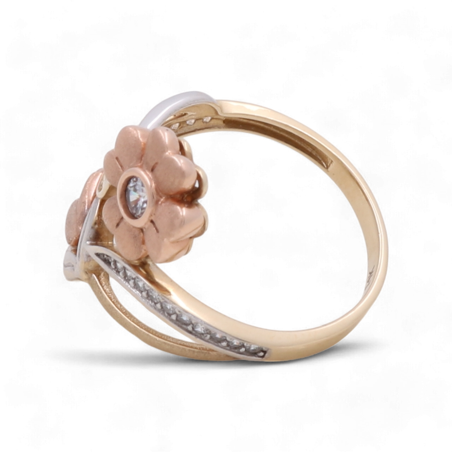 Miral Jewelry's 14K Yellow, White, and Rose Gold Flower Fashion Women's Ring features a stunning central zirconia gemstone and smaller gems along the band.