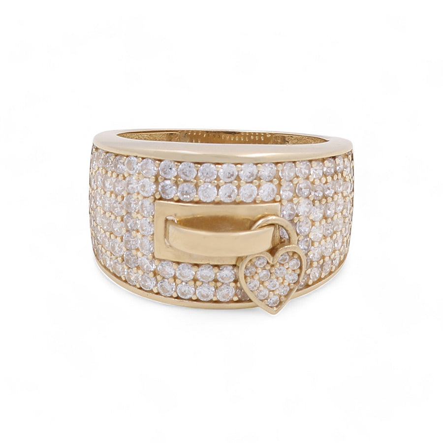 The 14K Yellow Gold Fashion Women's Ring with Cubic Zirconias from Miral Jewelry showcases a rectangular buckle design encrusted with numerous small cubic zirconia stones and includes a heart-shaped charm, also adorned with sparkling diamonds.