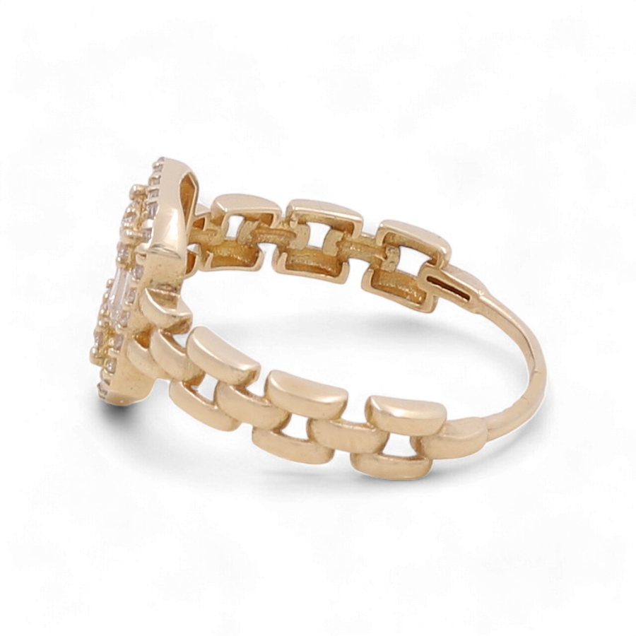 The 14K Yellow Gold Engagement Women's Ring by Miral Jewelry is designed with a band that resembles chain links and showcases a stunning gemstone setting on the front.