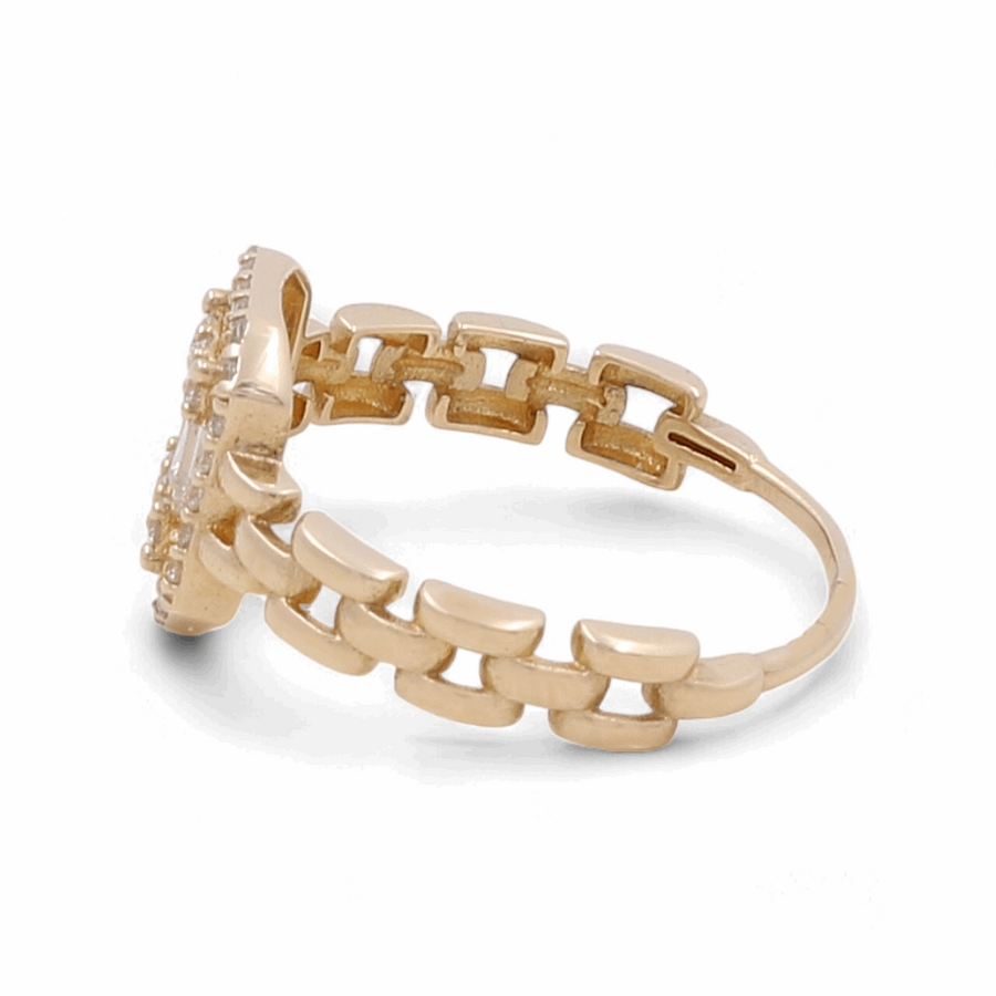 The 14K Yellow Gold Engagement Women's Ring by Miral Jewelry is designed with a band that resembles chain links and showcases a stunning gemstone setting on the front.