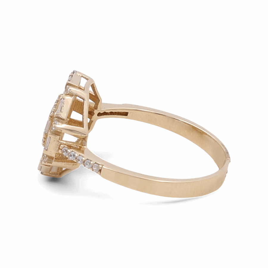 A side view of the Miral Jewelry 14K Yellow Gold Engagement Women's Ring reveals a stunning design, featuring a large central gemstone complemented by smaller diamonds elegantly embedded along the band.