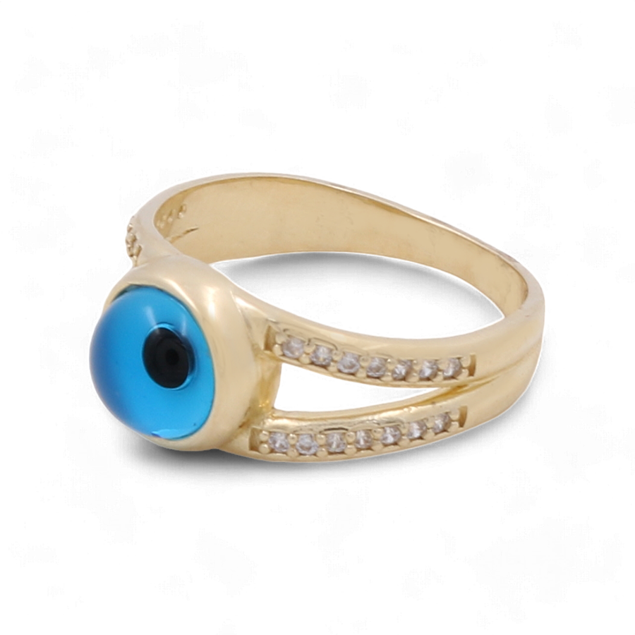 The 14K Yellow Gold Fashion Evil Eye with Zirconias Women's Ring by Miral Jewelry features a mesmerizing blue eye-like stone at the center, embodying the iconic Evil Eye motif. Flanked by small clear zirconias set in two elegant bands along the sides, this ring is a striking piece for any collection.