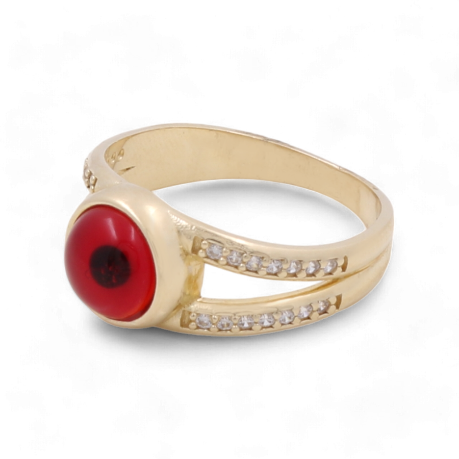 Miral Jewelry's 14K Yellow Gold Fashion Evil Eye Women's Ring features a centered red gemstone and sparkling clear zirconias set along its elegant split-shank band.