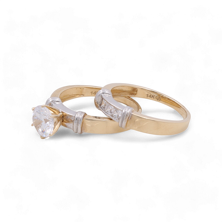 Two elegant bridal rings by Miral Jewelry: a 14K yellow gold engagement ring featuring a large central diamond, and another with smaller diamonds embedded along the band. Both bands are marked "14K.