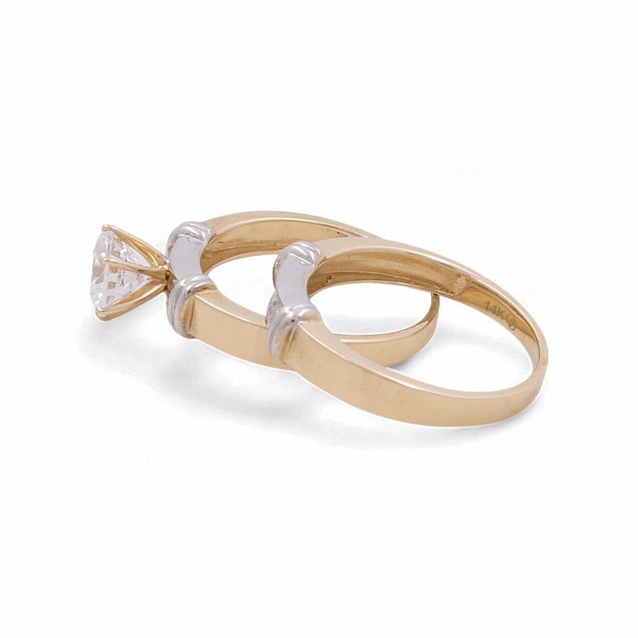 Two gold rings with 14K markings; one is the elegant **Miral Jewelry 14K Yellow Gold Engagement Women's Ring featuring a clear diamond solitaire**, while the other is a plain band, perfect as a timeless bridal ring.