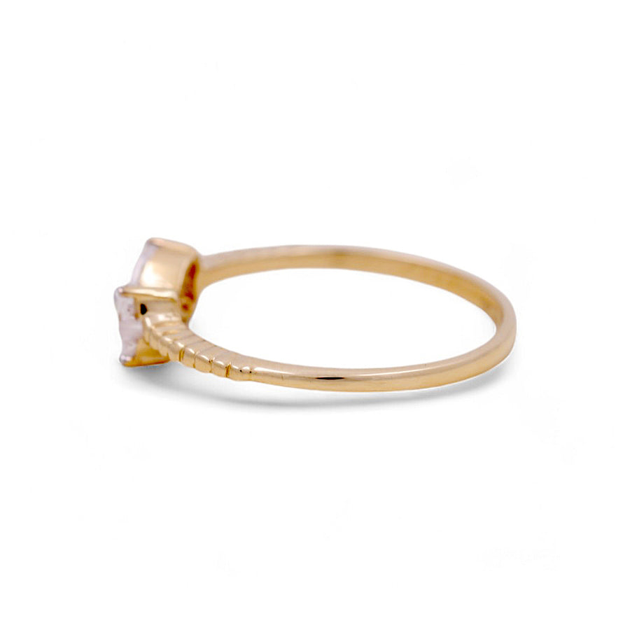 Chic side view of the Miral Jewelry 14K Yellow Gold Fashion Women's Ring showcasing a square-cut clear gemstone, complemented by smaller stones adorning the band.