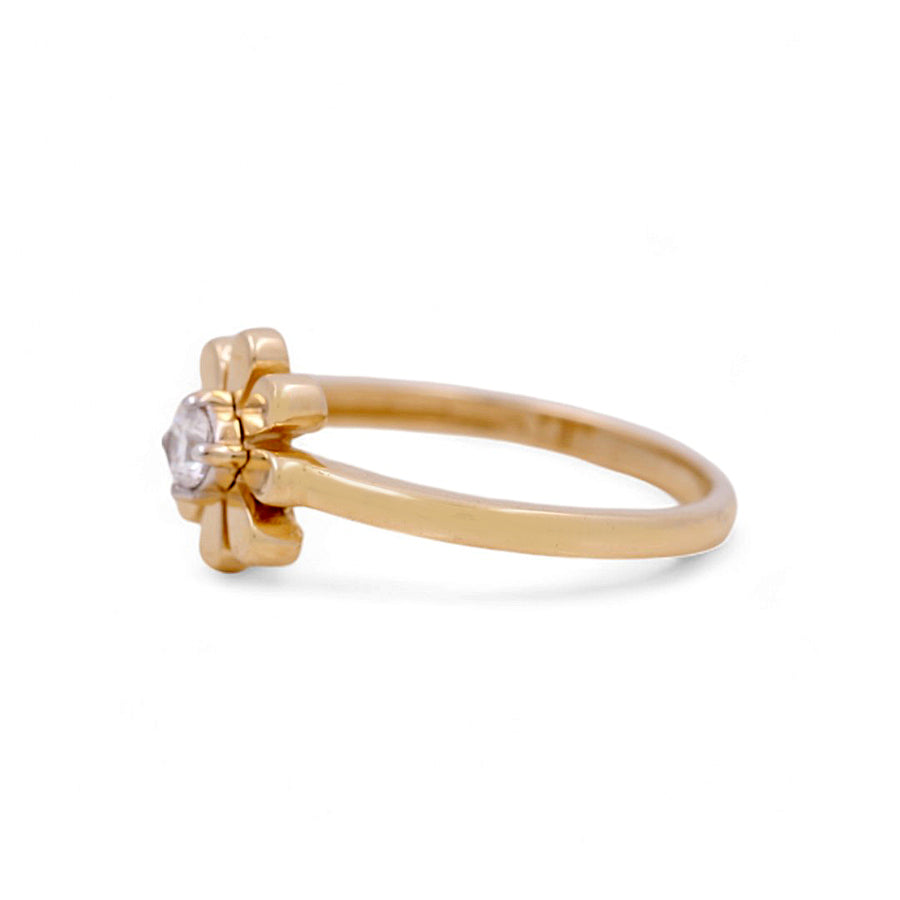 The 14K Yellow Gold Flower Fashion Women's Ring by Miral Jewelry is an exquisite women's ring designed with a flower-shaped setting and a radiant clear gemstone, elegantly showcased on a pristine white background.