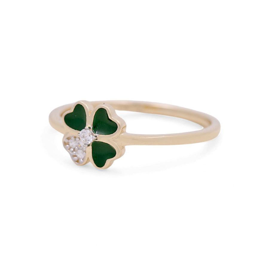 The 14K Yellow Gold Fashion Women's Ring by Miral Jewelry features a captivating green four-leaf clover design, embellished with small white stones on one leaf, all set against a crisp white background—an ideal fashion accessory for any occasion.