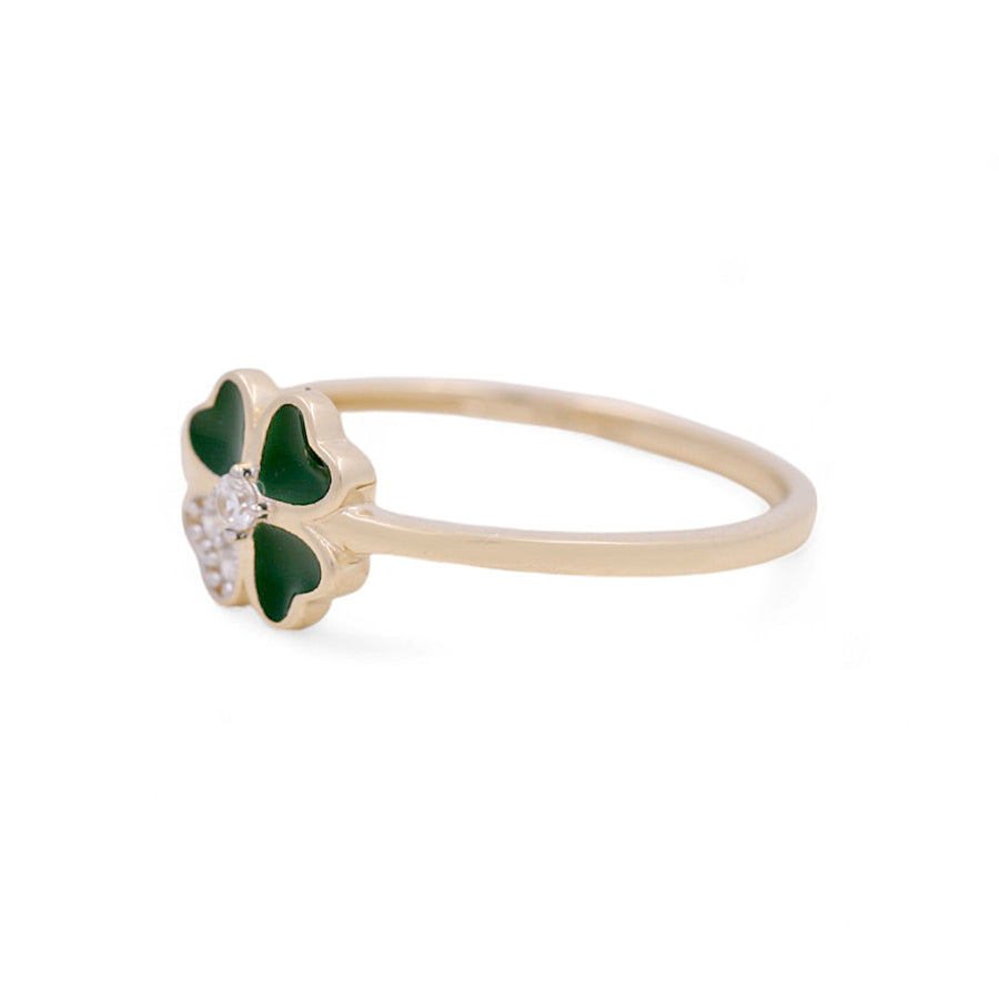 Miral Jewelry's 14K Yellow Gold Fashion Women's Ring showcases a green clover-shaped charm accented with small white stones at its center, creating a striking fashion accessory against a plain background.