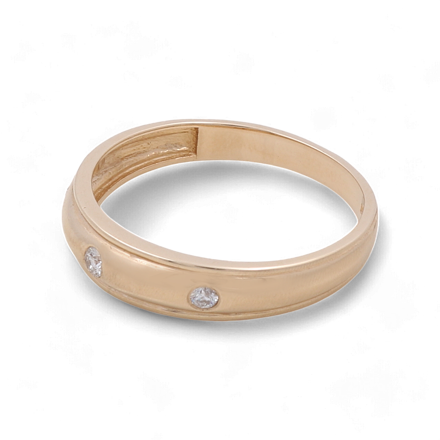 The 14K Yellow Gold Men's Wedding Band with Cubic Zirconias by Miral Jewelry features a smooth yellow and white gold band accented with three small cubic zirconias, and is photographed against a white background.