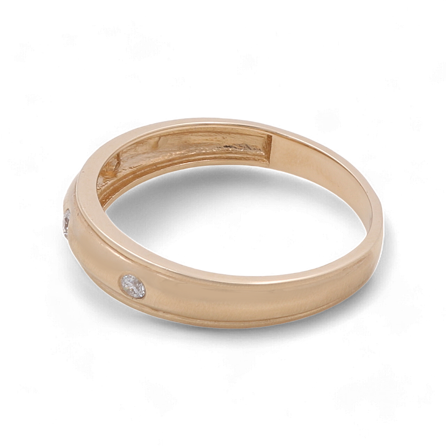 A 14K Yellow Gold Men's Wedding Band with embedded cubic zirconias by Miral Jewelry.