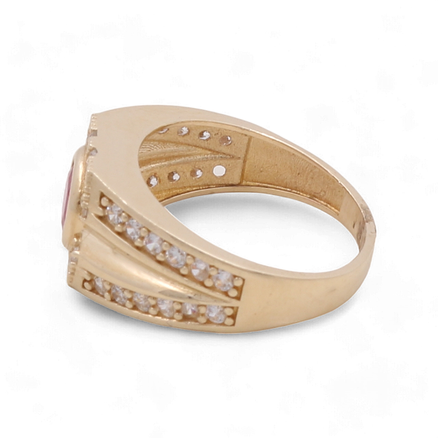 Miral Jewelry's 14K Yellow Gold Fashion Ring features a stunning pink center stone, accentuated by rows of small clear cubic zirconias on the sides.