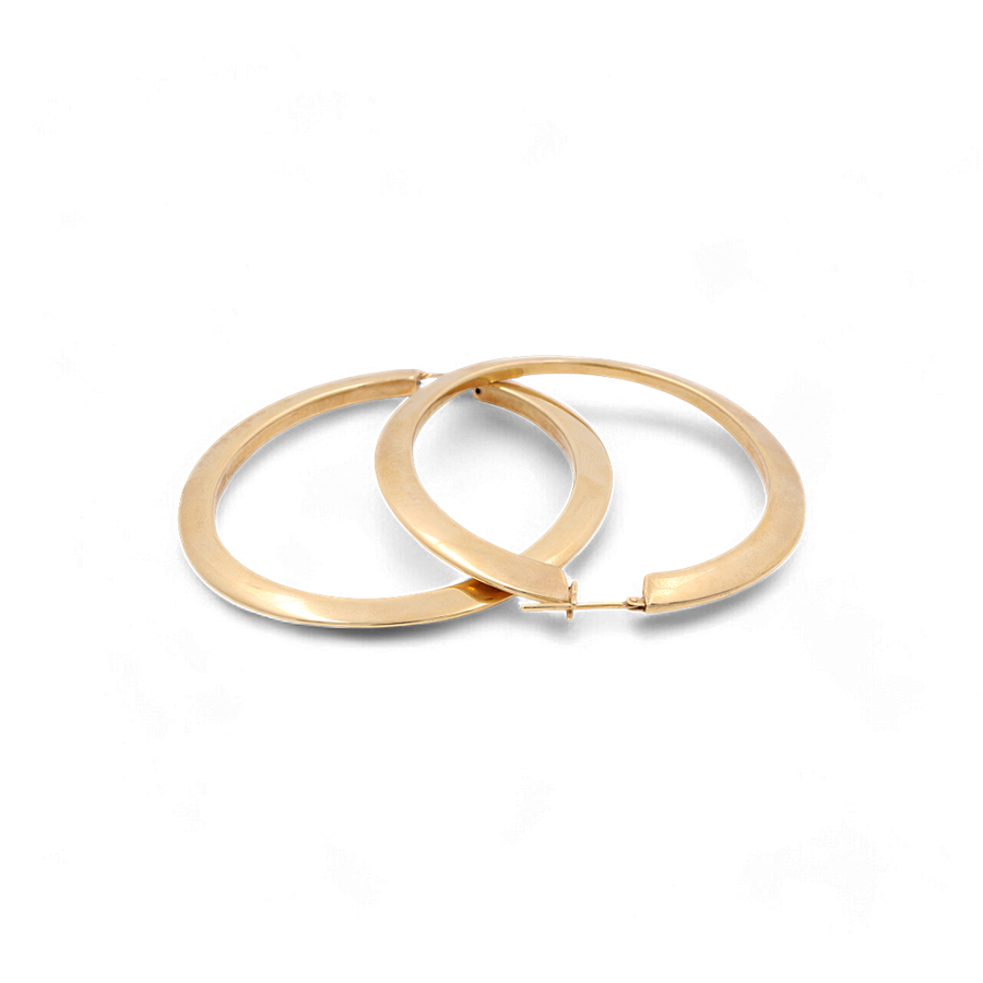 A pair of Miral Jewelry's 14K Yellow Gold Fashion Large Hoop Women's Earrings, exuding luxury with their smooth, shiny finish, laid next to each other on a white background.