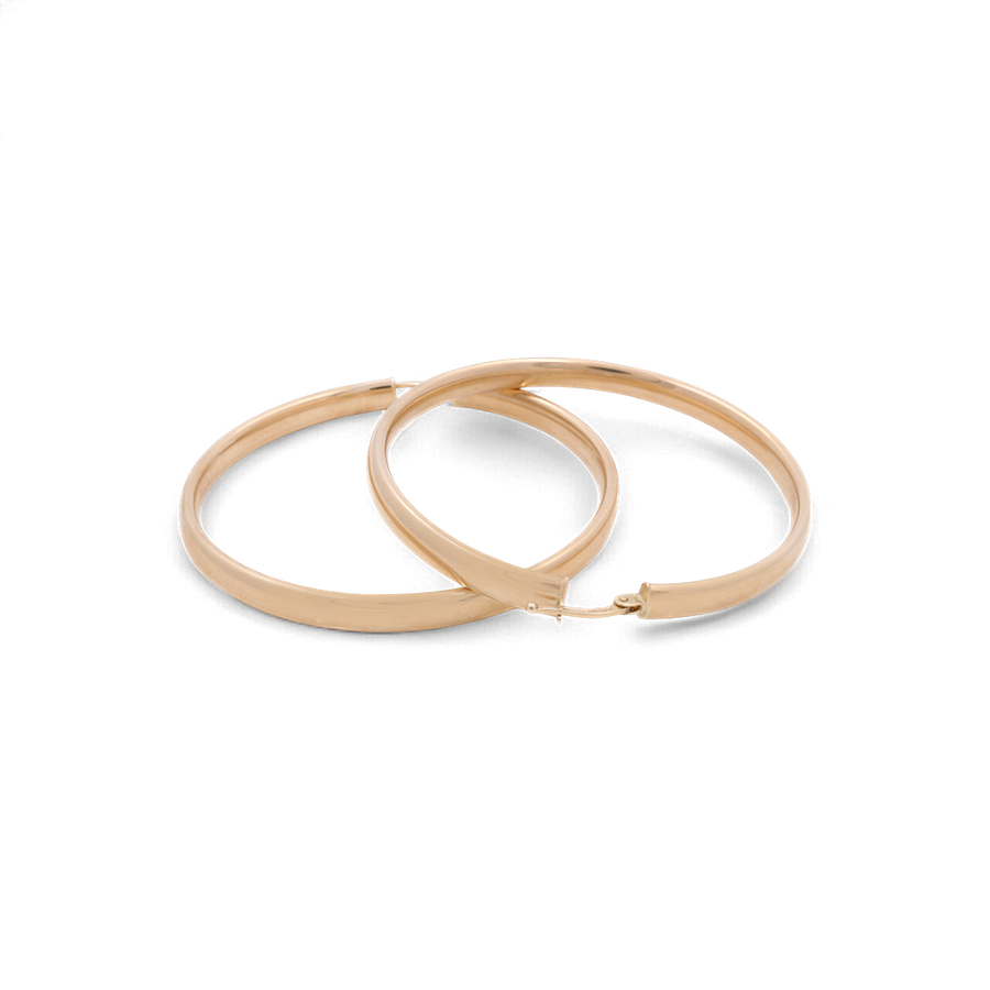 A pair of glamorous 10K Yellow Gold Medium Hoops Women's Earrings by Miral Jewelry, featuring a smooth, polished surface and shown against a white background, these earrings are a must-have accessory for any collection.