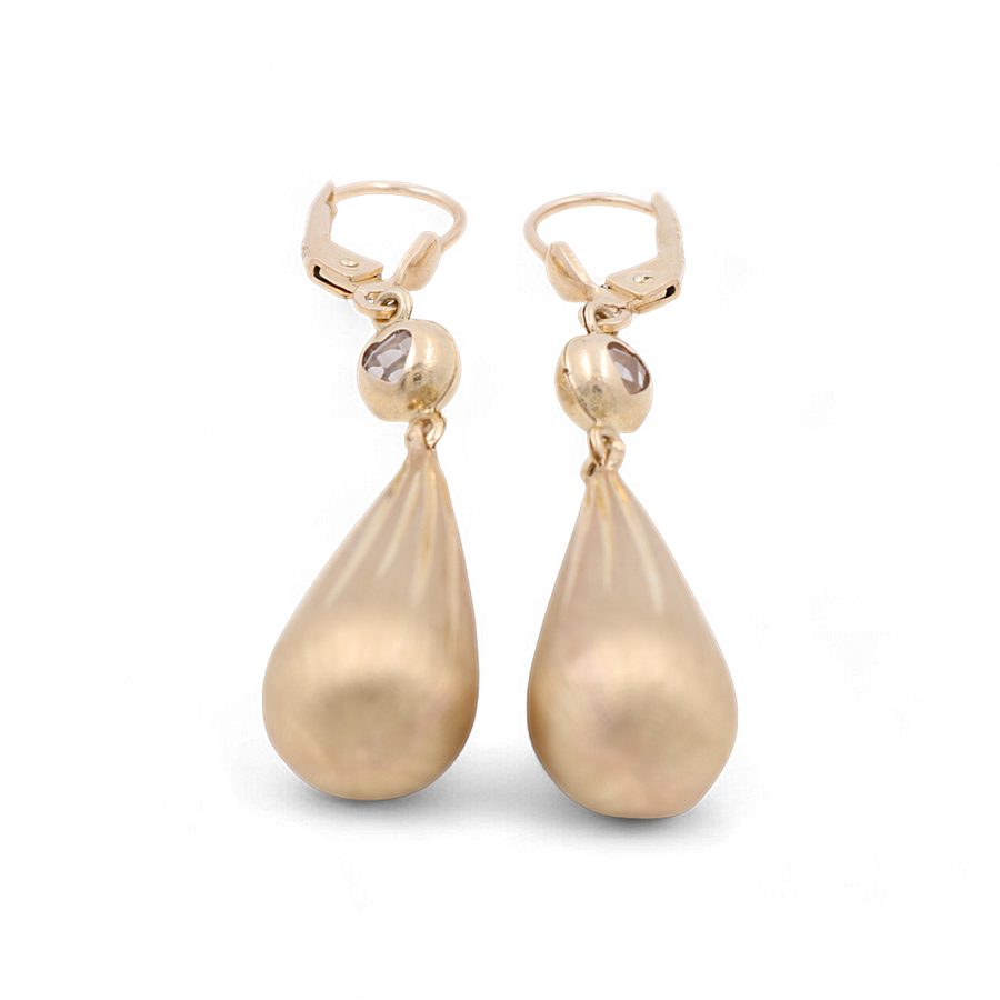 Crafted by Miral Jewelry, the 14K Yellow Gold Satin Drop Women's Earrings are luxurious and elegant accessories featuring a teardrop shape with a polished finish and a small spherical accent where the drop meets the clasp.