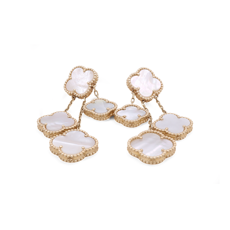 These stunning 14K Yellow Gold Fashion Flower Women's Mother of Pearl Earrings from Miral Jewelry exude elegance and charm. Featuring a clover design with mother-of-pearl inlays arranged in a cascading pattern, these gold earrings are the epitome of sophisticated style.