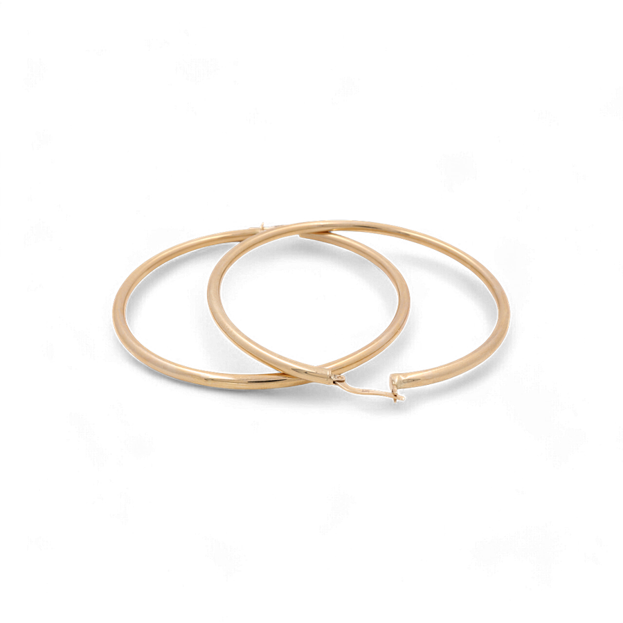 Two 14K Yellow Gold Large Hoop Women's Earrings by Miral Jewelry on a plain white background.