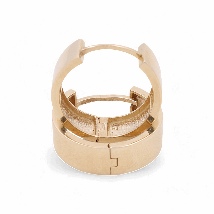 A 14K yellow gold cuff bracelet with a hinged clasp, viewed from an elevated angle against a white background, perfectly complements any pair of Miral Jewelry's 14K Yellow Gold Fashion Hoop Women's Earrings.