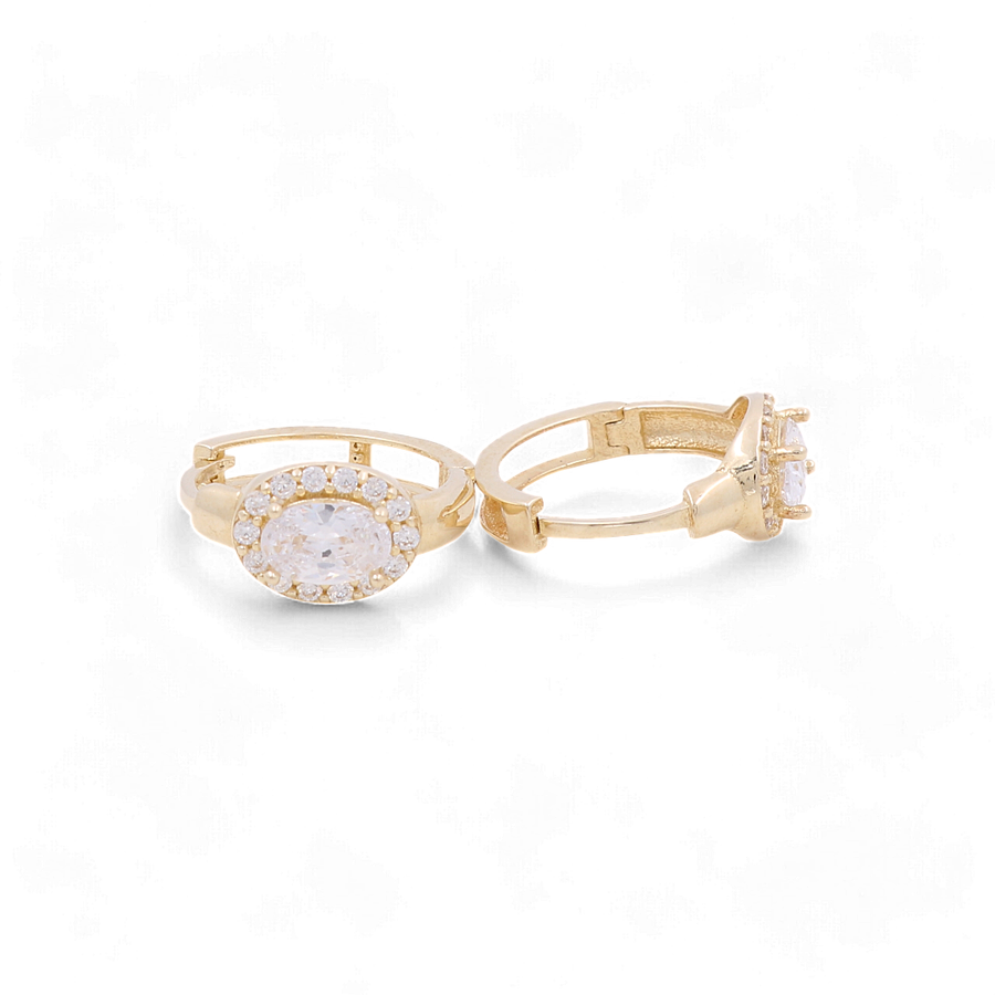 Two 14K yellow gold huggie earrings from Miral Jewelry, adorned with cubic zirconia stones and set against a plain white background, reminiscent of the elegance found in women's jewelry.