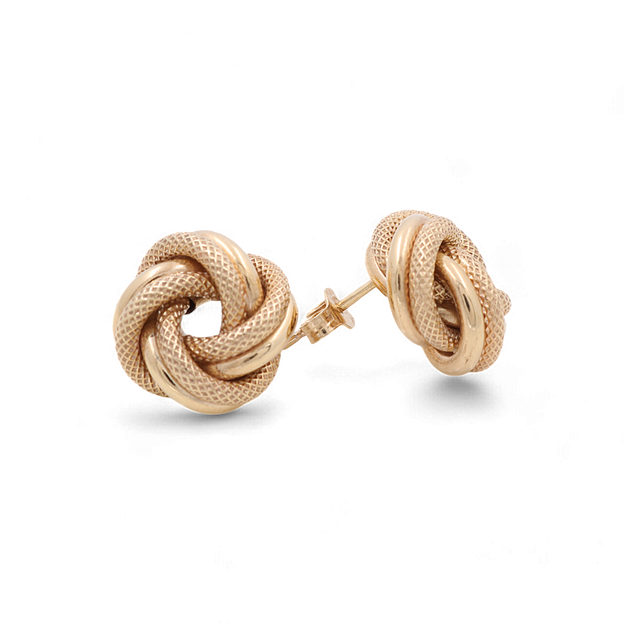 A pair of 14K Yellow Gold Knot Women's Earrings from Miral Jewelry, featuring a textured woven design and push-back closures, displayed against a white background. These high-quality gold knot studs radiate luxury and shine.