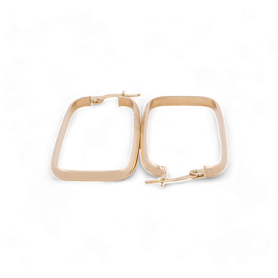 The 14K Yellow Gold Large Hoop Earrings by Miral Jewelry, featuring luxurious rectangular shapes and secure hinged clasps, are elegantly arranged side by side on a white background, epitomizing stylish jewelry.