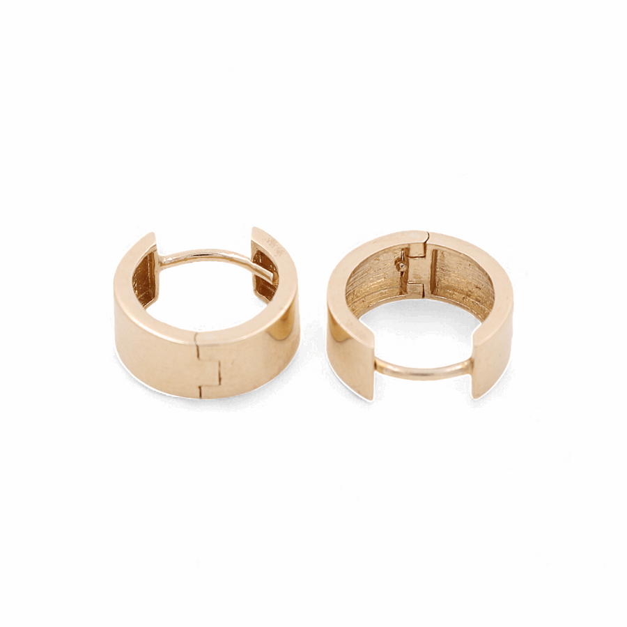 Miral Jewelry's 14K Yellow Fashion Hoop Earrings, featuring a twisted design and hinge closures, are displayed side by side on a white background, highlighting their unique and elegant style.