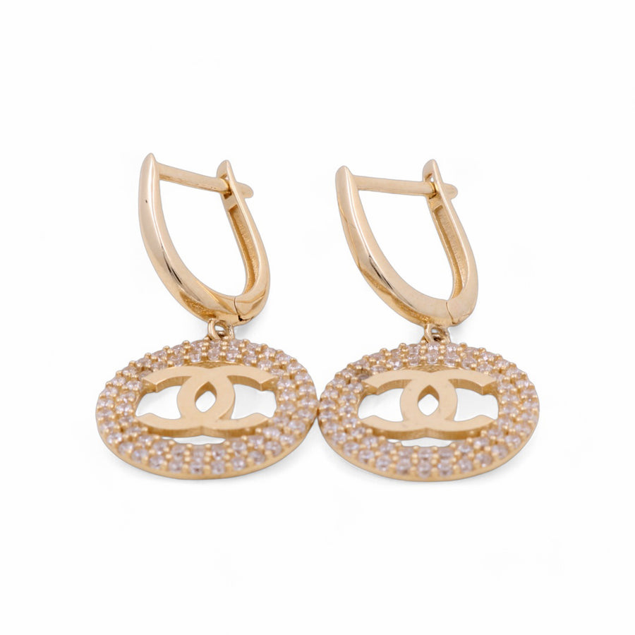 Miral Jewelry's pair of 14K Yellow Gold Earrings features round pendants with an interlocking double-C design, embedded with small, clear gemstones.