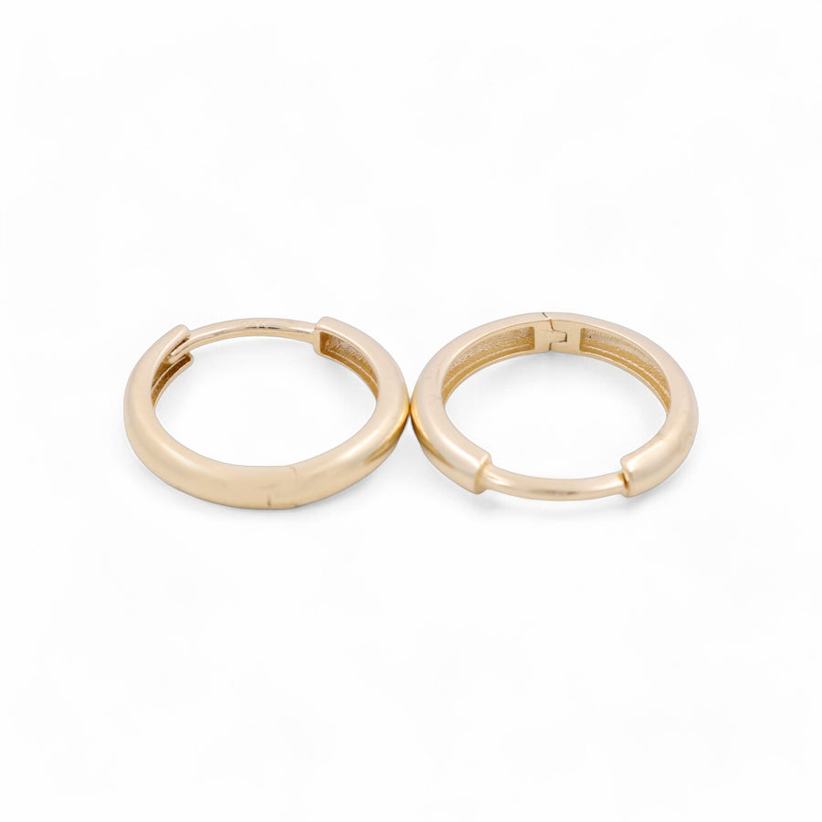 Two stylishly designed 14K Yellow Fashion Hoops Earrings by Miral Jewelry, featuring convenient clasp mechanisms, positioned side by side on a white background.