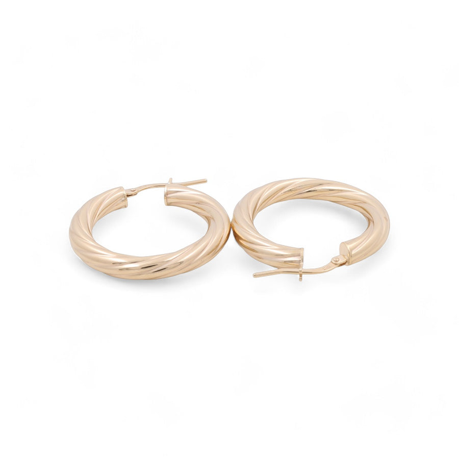 Miral Jewelry’s 14K Yellow Gold Fashion Hoop Earrings, showcased against a white background, feature one earring closed and the other open. Experience the epitome of luxury jewelry with these elegant gold twisted hoops.