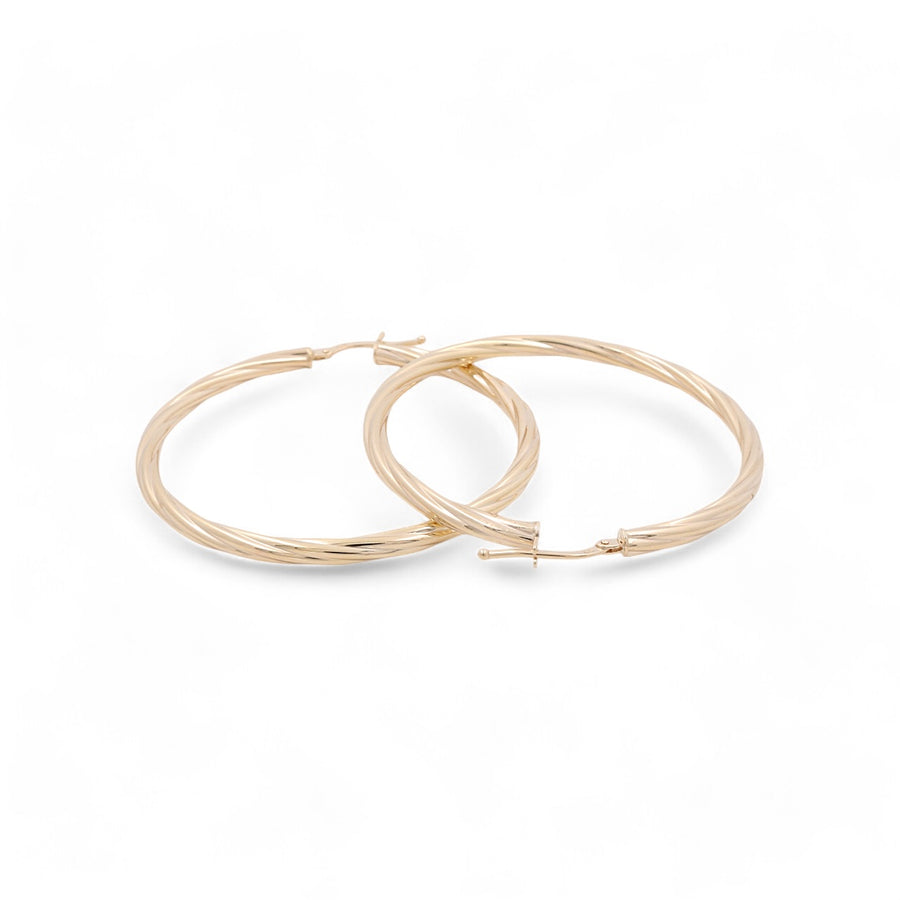 A pair of Miral Jewelry's 14K yellow gold hoop earrings with a classic twisted design, displayed on a white background.