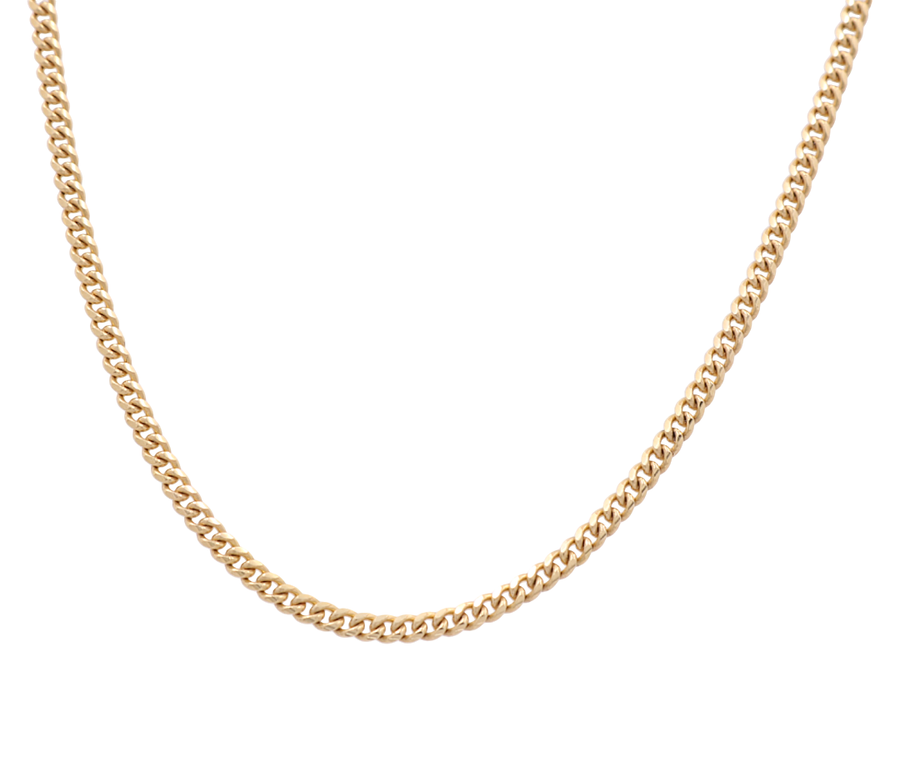 A timeless classic, the 14k Yellow Gold Cuban Link Chain from Miral Jewelry features a sleek 14k yellow gold design on a white background.