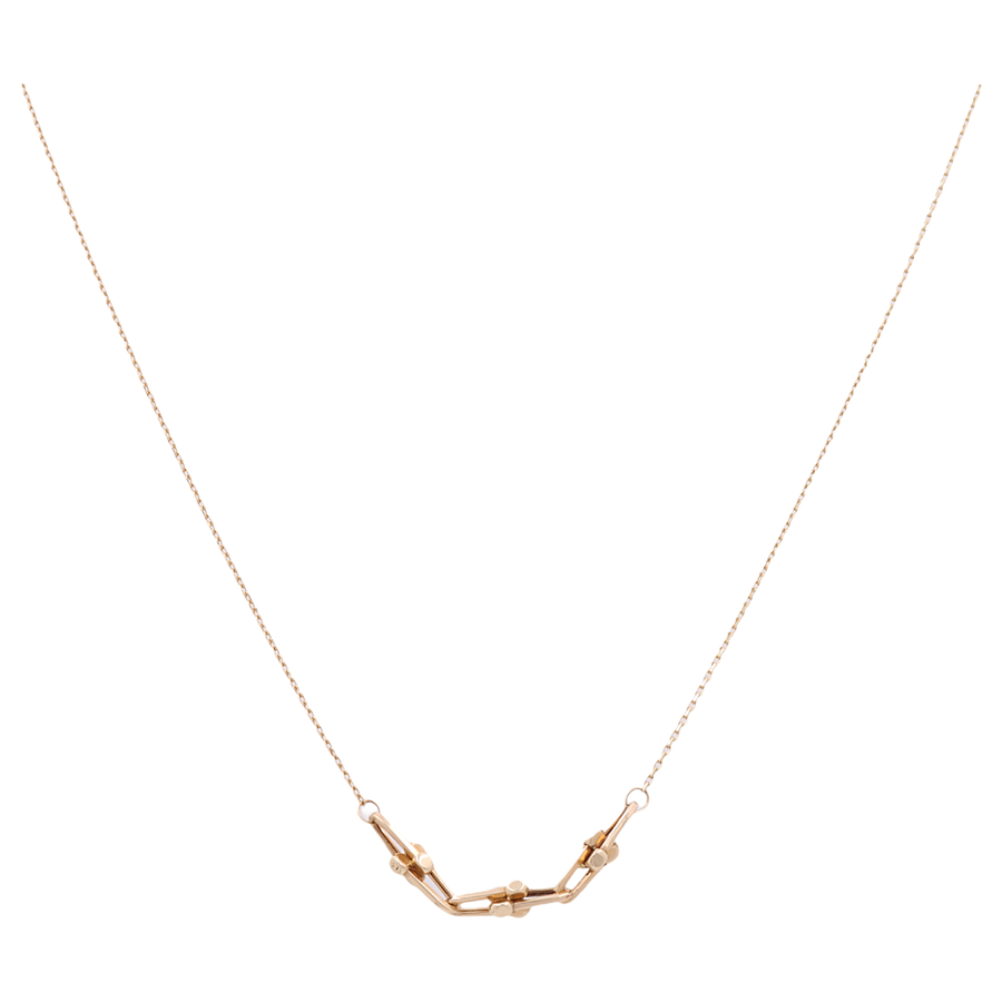 A luxurious accessory from Miral Jewelry, this 14K Yellow Gold Necklace features an elegant chain and a small geometric pendant in the center, consisting of several linked gold shapes.