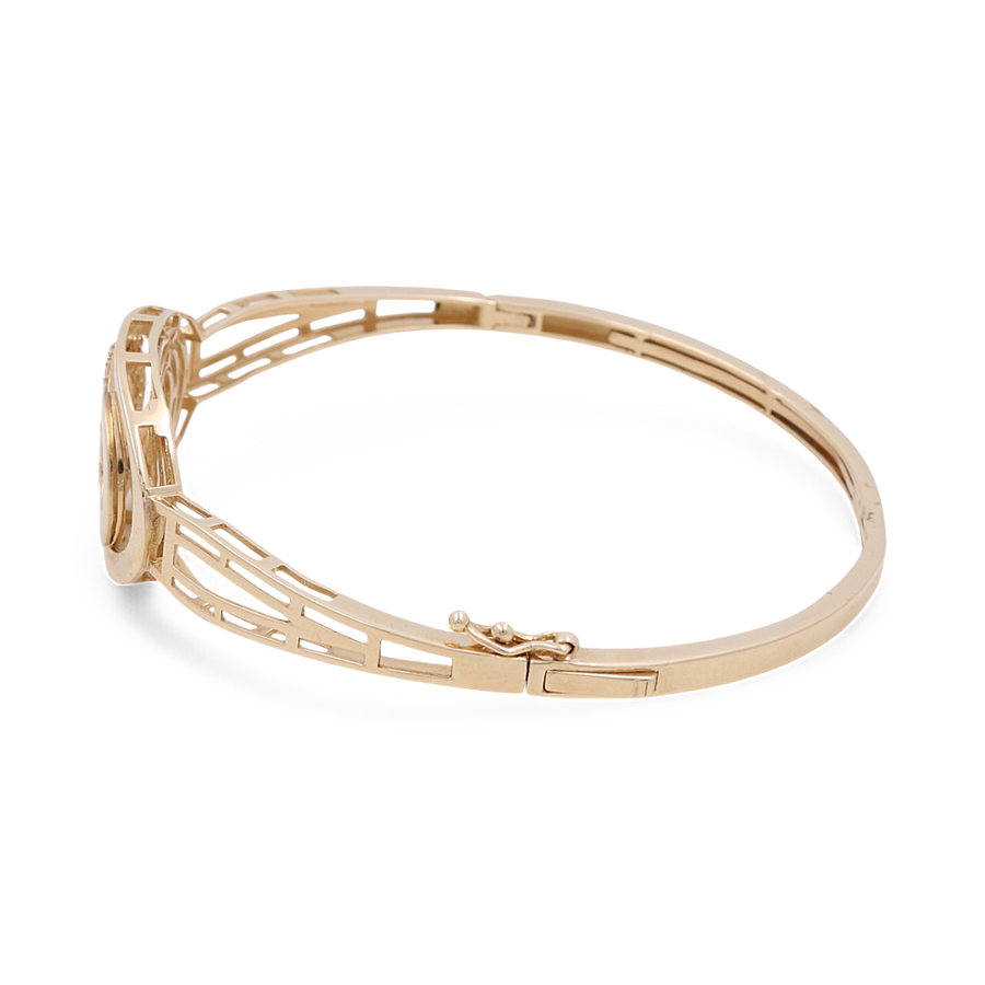 A stylish accessory, the Miral Jewelry 14K Yellow Gold Fashion Bangle Bracelet features an openwork design and is displayed in a side view with a clasp closure.