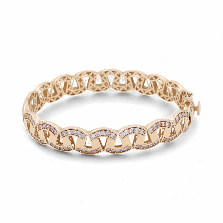 The 14K Yellow Gold Fashion Bracelet by Miral Jewelry features a linked chain design and is studded with small diamonds, epitomizing luxury jewelry.