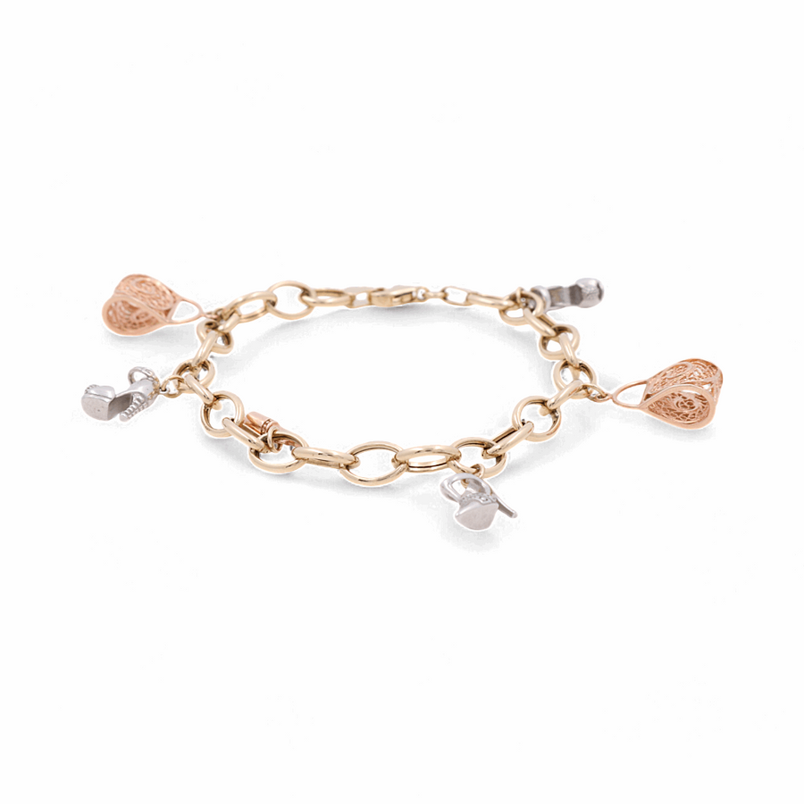 Presenting the 14K Yellow Gold Fashion Bracelet by Miral Jewelry, a stunning piece adorned with alternating silver and gold heart-shaped charms, perfect for any fashion-forward individual.