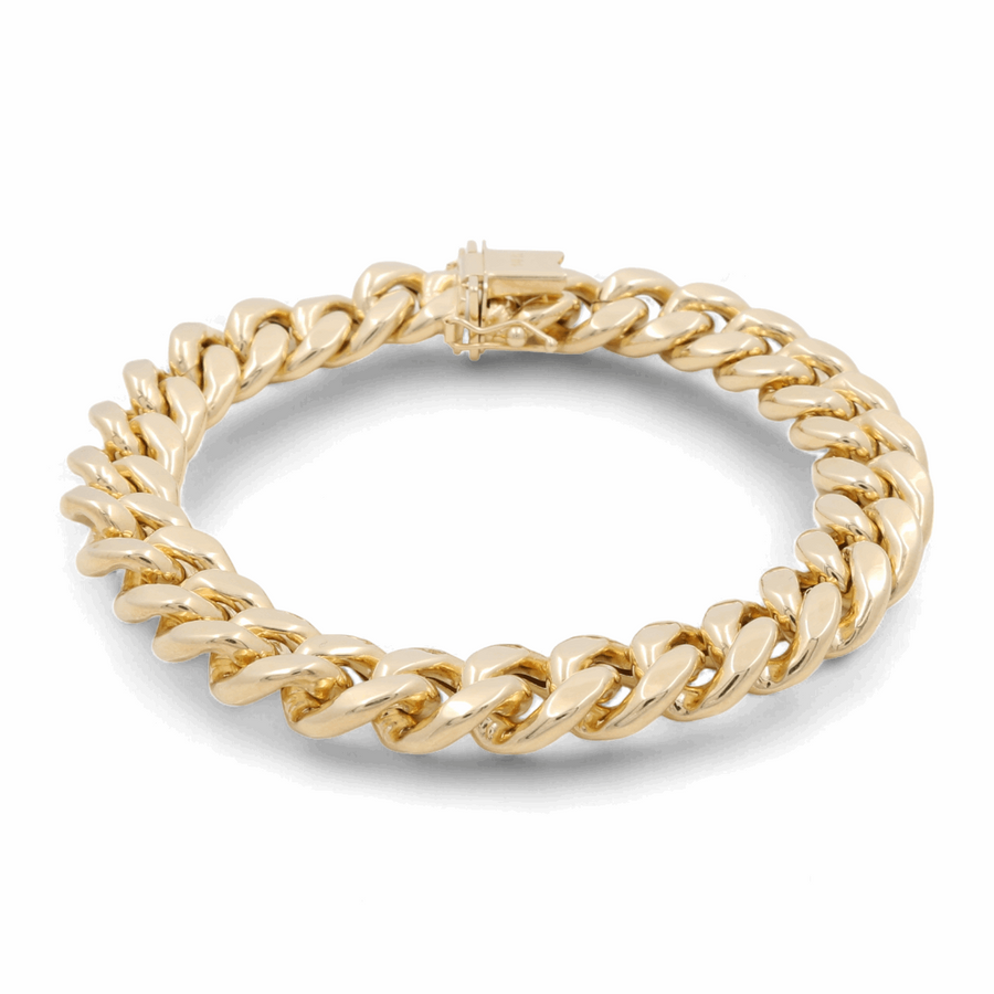 14K yellow gold chain bracelet with a clasp, displayed on a white background. This 14K Yellow Gold Fashion Cuban Links Bracelet by Miral Jewelry features exquisite fashion links perfect for any occasion.