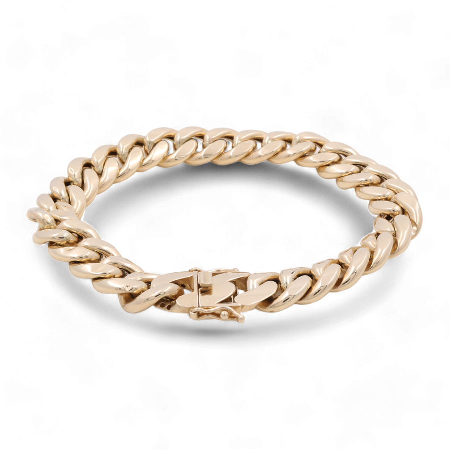 A Miral Jewelry 14K Yellow Gold Fashion Cuban Links Bracelet with thick, interlocking links and a clasp is depicted against a plain white background, showcasing a truly luxurious accessory.