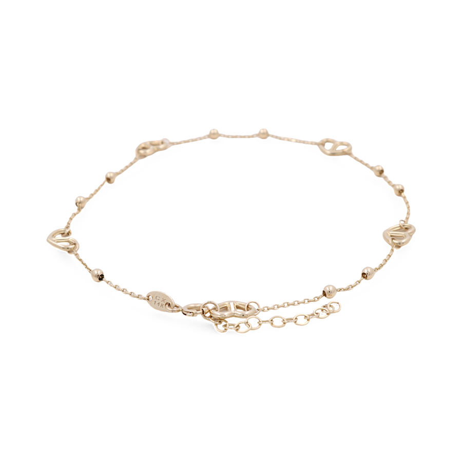 The Miral Jewelry 14K Yellow Fashion Women's Ankle Bracelet is a delicate accessory featuring small heart-shaped charms spaced evenly along the chain, complete with an adjustable clasp closure, making it perfect for a subtle yet stunning fashion statement.