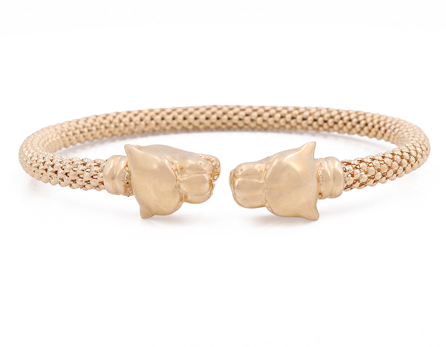 A Miral Jewelry 14K Yellow Gold Panther and Mesh Bracelet with two lion heads on it.