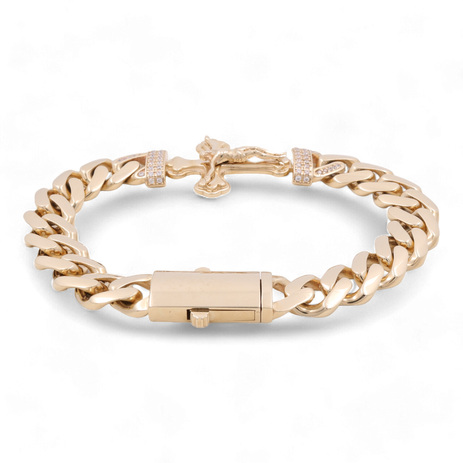 A stunning 14K Yellow Gold Fashion Cross with Cubic Zirconias Bracelet by Miral Jewelry, this fashion accessory features a secure clasp and decorative elements, all showcased on a sleek black background.