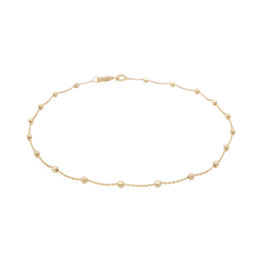 Miral Jewelry's 14K Yellow Gold Women's Ankle Bracelet features a delicate chain adorned with small beaded accents and a secure clasp closure.