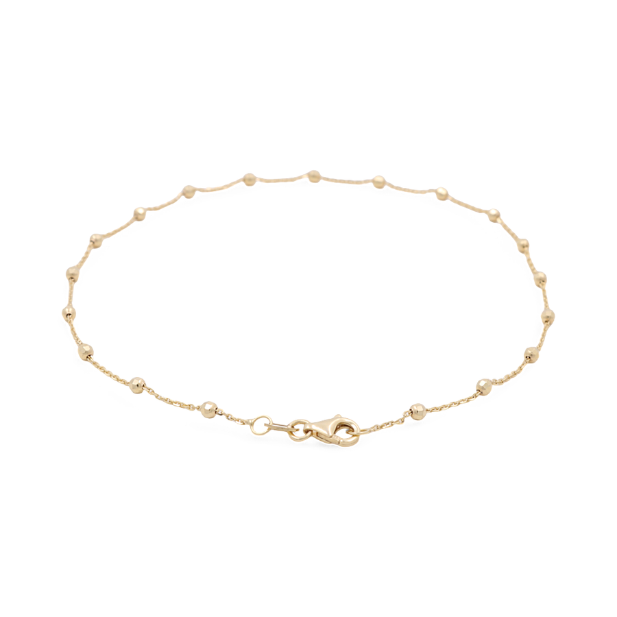 Introducing the Miral Jewelry 14K Yellow Gold Women's Ankle Bracelet, featuring a delicate chain adorned with small round beads and hearts evenly spaced along its length, complete with a secure lobster clasp closure.