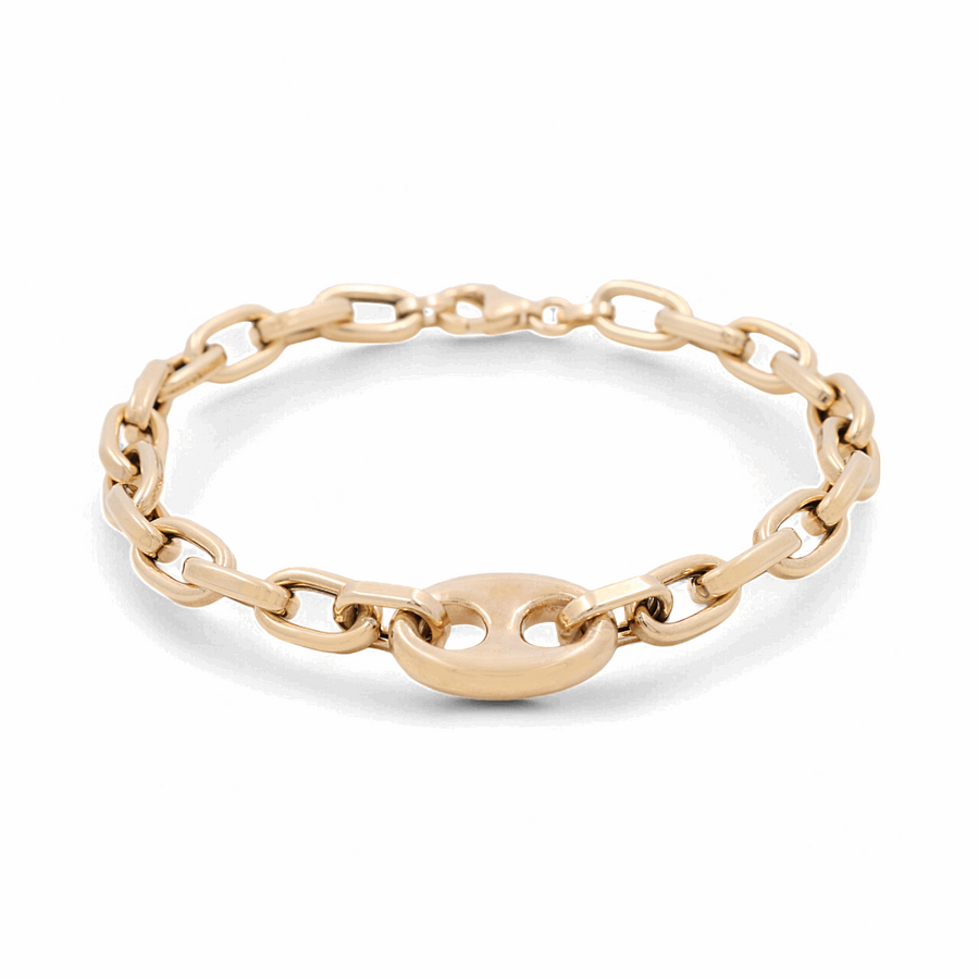 An elegant accessory from Miral Jewelry, the 14K Yellow Gold Fashion Links Bracelet showcases interlocking chain links in both yellow and white gold, highlighted by a central oval link, all beautifully displayed on a white background.