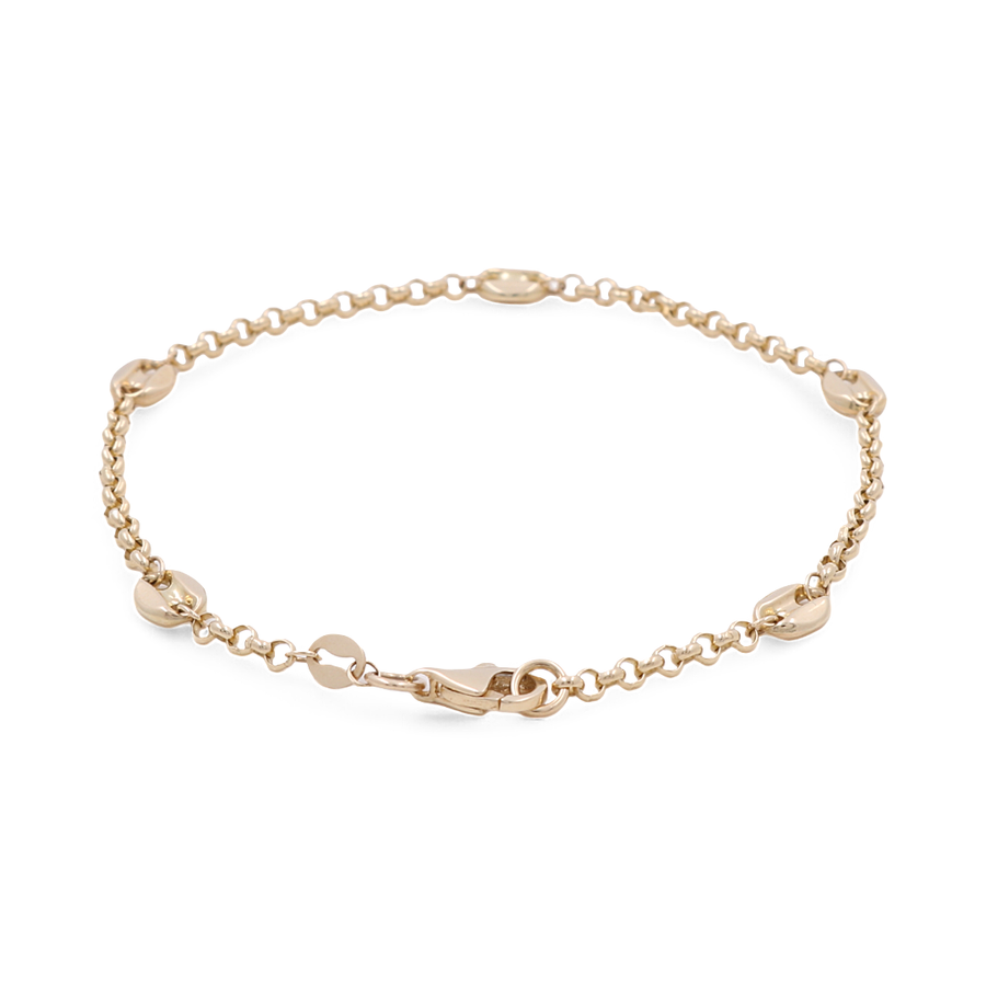 The 14K Yellow Gold Women's Bracelet with Fashion Link by Miral Jewelry boasts a delicate chain link design adorned with several small round charms and a secure lobster clasp closure. This elegant accessory is perfect for adding a touch of sophistication to any outfit.