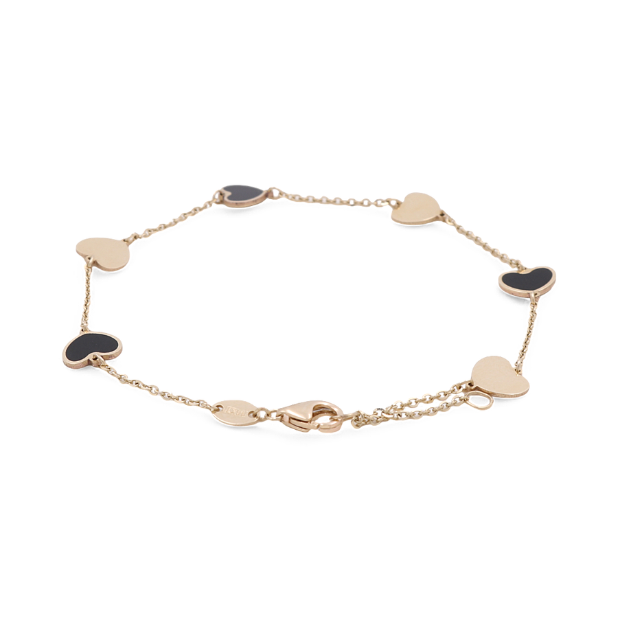 The 14K Yellow Gold Fashion Hearts Women's Onyx and Gold Bracelet by S showcases a beautiful design with alternating black and gold heart-shaped charms in 14K yellow gold.